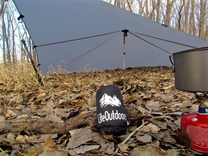 A LiteOutdoors Silnylon Tarp shown packed in a compact carry case.